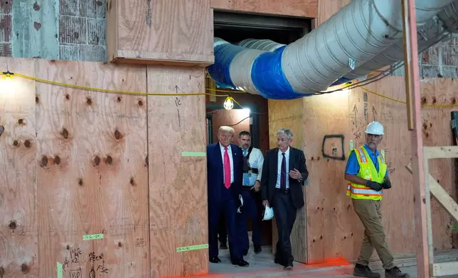 FILE- President Donald Trump, left, and Federal Reserve Chairman Jerome Powell, second right, visit the Federal Reserve, Thursday, July 24, 2025, in Washington. (AP Photo/Julia Demaree Nikhinson, File)