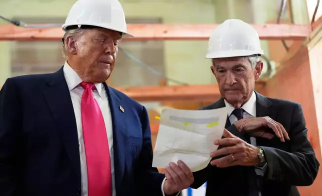 FILE- FILE - Federal Reserve Chairman Jerome Powell, right, and President Donald Trump look over a document of cost figures during a visit to the Federal Reserve, Thursday, July 24, 2025, in Washington. (AP Photo/Julia Demaree Nikhinson, File)
