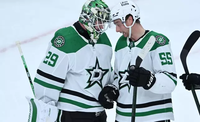 Dallas Stars goalie Jake Oettinger (29) celebrates with teammate Thomas Harley (55) after defeating the Chicago Blackhawks in an NHL hockey game Saturday, Oct. 17, 2026, in Chicago. (AP Photo/Paul Beaty)