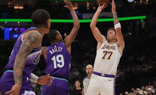 Los Angeles Lakers forward/guard Luka Dončić (77) looks to shoots as Utah Jazz forward Ace Bailey (19) defends during the first half of an NBA basketball game Sunday, Oct. 25, 2026, in Salt Lake City. (AP Photo/Bethany Baker)