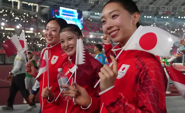 Japanese athletes react during the closing ceremony for the Asian Games in Nagoya, Japan, Sunday, Oct. 4, 2026. (AP Photo/Lee Jin-man)