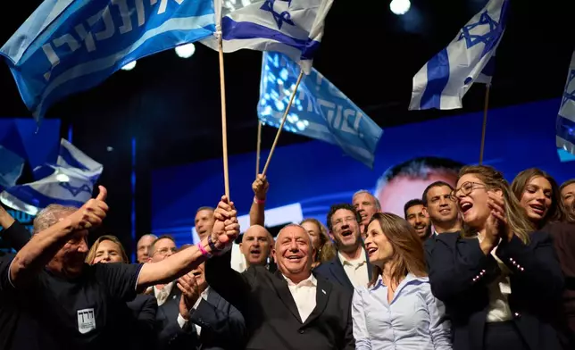 Gadi Eisenkot, leader of the Yashar ("Straight") party, waves an Israeli flag after speaking at a campaign rally ahead of the country's general election, Sunday, Oct. 25, 2026, in Tel Aviv, Israel. (AP Photo/David Goldman)