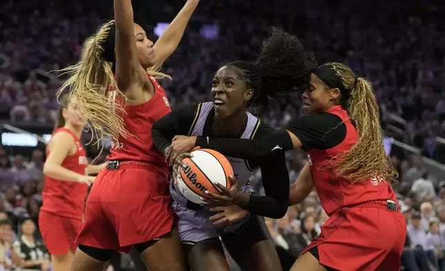 Golden State Valkyries forward Laeticia Amihere, middle, drives to the basket against Atlanta Dream forward Naz Hillmon, left, and guard Jordin Canada during the first half of Game 1 of the WNBA basketball finals, Saturday, Oct. 17, 2026, in San Francisco. (AP Photo/Jeff Chiu)