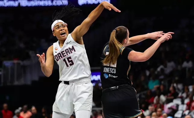 Atlanta Dream guard Allisha Gray (15) is fouled by New York Liberty guard Sabrina Ionescu, right, during the first half in Game 1 of the WNBA basketball semifinalsSunday, Oct, 4, 2026, in Atlanta. (AP Photo/Colin Hubbard)