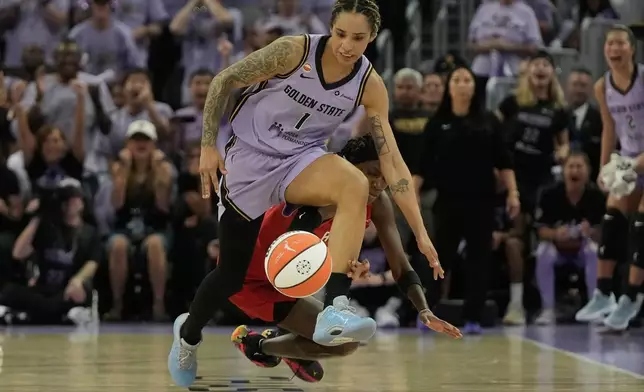 Golden State Valkyries forward Gabby Williams (1) runs toward the ball against Atlanta Dream guard Rhyne Howard during the first half of Game 1 of the WNBA basketball finals, Saturday, Oct. 17, 2026, in San Francisco. (AP Photo/Jeff Chiu)
