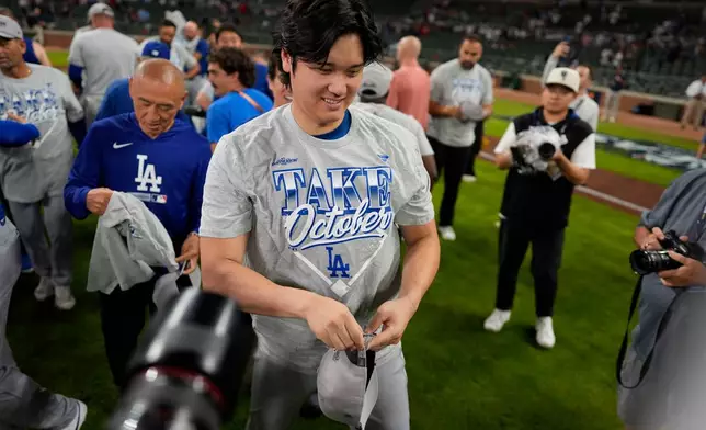 Los Angeles Dodgers two-way player Shohei Ohtani celebrates winning Game 4 of baseball's National League Division Series against the Atlanta Braves, Wednesday, Oct. 7, 2026, in Atlanta. (AP Photo/Mike Stewart)