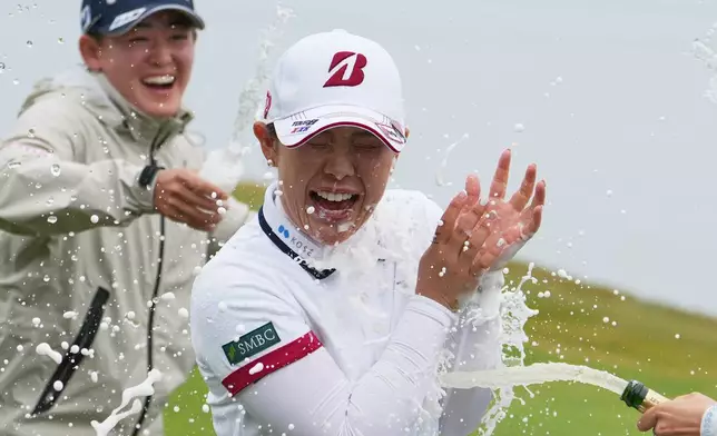 Yuri Yoshida of Japan gets showered with champagne on the 18th green after her win following the final round of the LPGA BMW Ladies Championship at the Pine Beach Golf Links, in Haenam, South Korea, Sunday, Oct. 25, 2026. (AP Photo/Lee Jin-man)