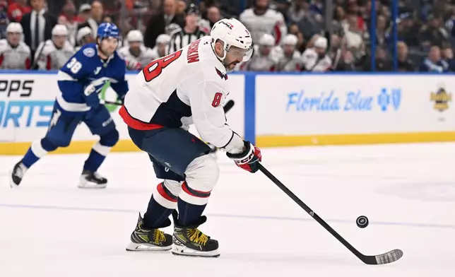 Washington Capitals left wing Alex Ovechkin (8) handles the puck during the third period of an NHL hockey game against the Tampa Bay Lightning Saturday, Oct. 3, 2026, in Tampa, Fla. (AP Photo/Jason Behnken)