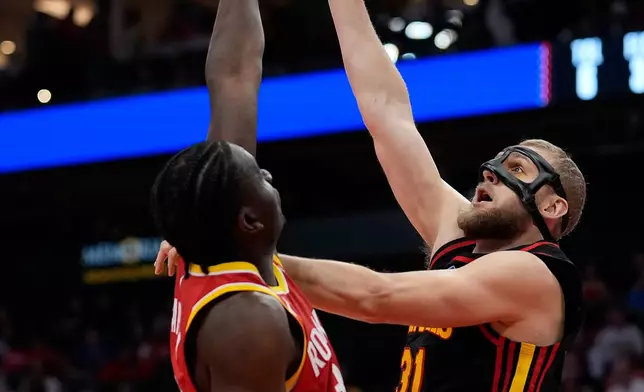 Atlanta Hawks center Jock Landale, top right, is defended by Houston Rockets center Clint Capelam, top left, during the first quarter of an NBA basketball game Monday, Oct. 26, 2026, in Houston. (AP Photo/Kevin M. Cox)