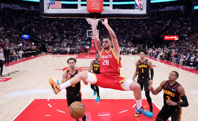 Houston Rockets center Alperen Sengun (28) dunks during the first quarter of an NBA basketball game against the Atlanta Hawks, Monday, Oct. 26, 2026, in Houston. (AP Photo/Kevin M. Cox)