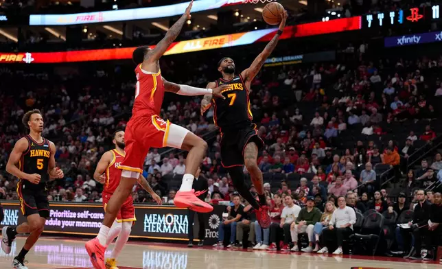 Atlanta Hawks guard Nickeil Alexander-Walker (7) is defended byHouston Rockets forward Jabari Smith Jr., front left, during the first quarter of an NBA basketball game Monday, Oct. 26, 2026, in Houston. (AP Photo/Kevin M. Cox)