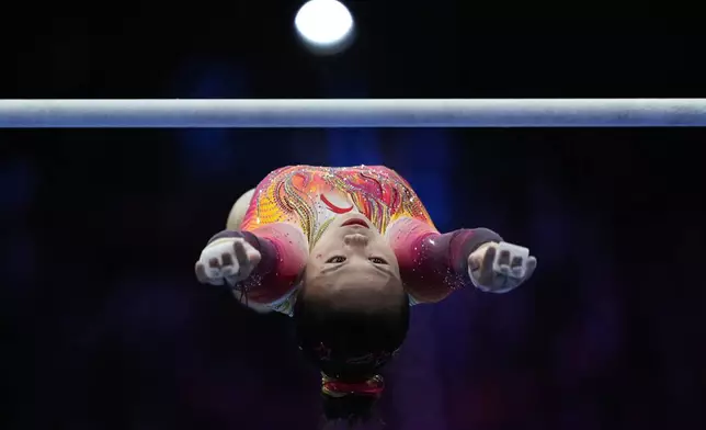 Zhang Qingying, of China, competes in the uneven bars during the women's team final at the Artistic Gymnastics World Championships in Rotterdam, the Netherlands, Wednesday, Oct. 21, 2026. (AP Photo/Francisco Seco)