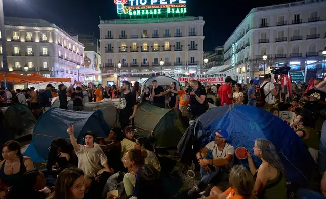 People set up tents during a protest following the eviction last Wednesday of 87-year-old Maricarmen to demand stronger laws to protect renters at Sol square in Madrid, Spain, Saturday, Sept. 26, 2026. (AP Photo/Manu Fernandez)