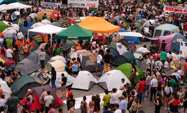 Protesters camp during a protest following the eviction last Wednesday of 87-year-old Maricarmen to demand stronger laws to protect renters at Sol square in Madrid, Spain, Sunday, Sept. 27, 2026. (AP Photo/Manu Fernandez)