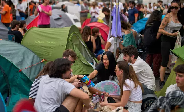 Protesters camp during a protest following the eviction last Wednesday of 87-year-old Maricarmen to demand stronger laws to protect renters at Sol square in Madrid, Spain, Sunday, Sept. 27, 2026. (AP Photo/Manu Fernandez)