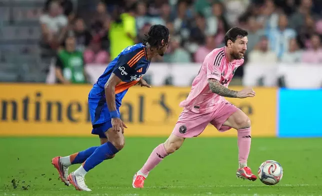 Inter Miami forward Lionel Messi, right, is pursued by FC Cincinnati forward Kenji Mboma Dem during the first half of an MLS soccer match, Wednesday, Oct. 28, 2026, in Miami. (AP Photo/Rebecca Blackwell)