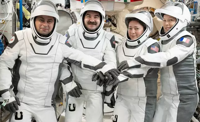 This image provided by NASA on Tuesday Oct. 6, 2026, SpaceX Crew-12 members, from left, Roscosmos cosmonaut and mission specialist Andrey Fedyaev, NASA astronauts Jack Hathaway and Jessica Meir, Crew-12 pilot and commander respectively, and ESA (European Space Agency) astronaut and mission specialist Sophie Adenot, gather for a portrait in the pressure suits they will wear when they depart the International Space Station inside the SpaceX Dragon spacecraft. (Anil Menon/NASA via AP)