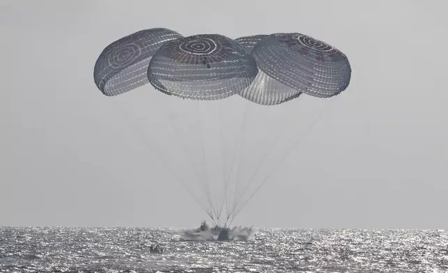 In this photo provided by NASA, the SpaceX Crew Dragon Freedom spacecraft splashes down in the Pacific Ocean off the coast of California on Thursday, Oct. 8, 2026, returning from the International Space Station. (Keegan Barber/NASA via AP)