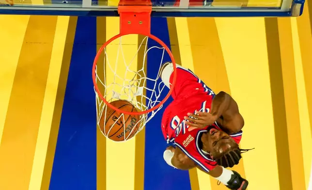 Philadelphia 76ers' Tyrese Maxey dunks during the first half of an NBA Cup basketball game against the New York Knicks, Friday, Oct. 30, 2026, in Philadelphia. (AP Photo/Chris Szagola)
