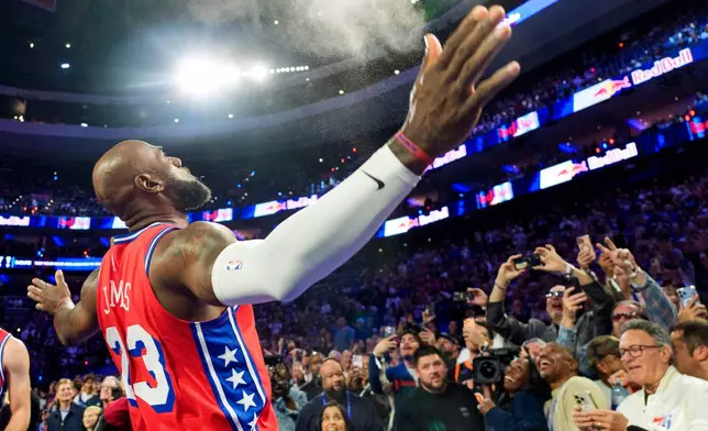 Philadelphia 76ers' LeBron James (23) does his chalk toss prior to an NBA Cup basketball game against the New York Knicks, Friday, Oct. 30, 2026, in Philadelphia. (AP Photo/Chris Szagola)
