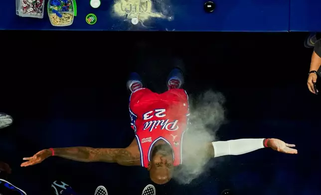 Philadelphia 76ers' LeBron James does his chalk toss prior to an NBA Cup basketball game against the New York Knicks, Friday, Oct. 30, 2026, in Philadelphia. (AP Photo/Chris Szagola)