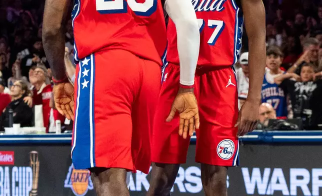 Philadelphia 76ers' VJ Edgecombe, right, looks at LeBron James, left, after James made a basket during the second half of an NBA Cup basketball game against the New York Knicks, Friday, Oct. 30, 2026, in Philadelphia. (AP Photo/Chris Szagola)