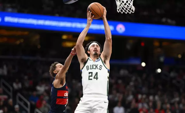 Milwaukee Bucks guard Jaime Jaquez Jr. (24) goes to the basket past Washington Wizards guard Trae Young, left, during the first half of an NBA basketball game, Wednesday, Oct. 21, 2026, in Washington. (AP Photo/Nick Wass)