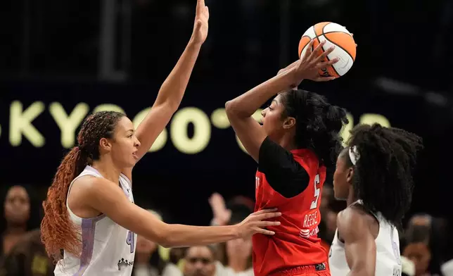 Atlanta Dream's Angel Reese (5) looks to pass past Golden State Valkyries' Juste Jocyte during the first half of Game 6 of the WNBA basketball finals on Thursday, Oct. 29, 2026, in Atlanta. (AP Photo/Brynn Anderson)