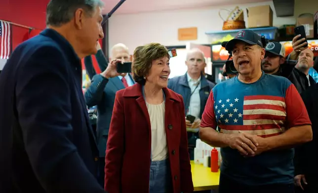Sen. Susan Collins, with former West Virginia Sen. Joe Manchin, left, talk with Jimmy Simones at his restaurant Wednesday, Oct. 21, 2026, in Lewiston, Maine. (AP Photo/Robert F. Bukaty)