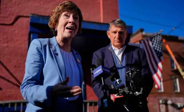 Sen. Susan Collins, with former West Virginia Sen. Joe Manchin, speaks to reporters following a campaign stop Wednesday, Oct. 21, 2026, in Lewiston, Maine. (AP Photo/Robert F. Bukaty)