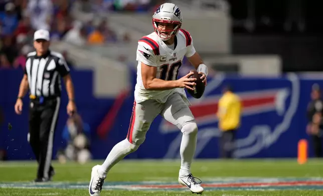 New England Patriots quarterback Drake Maye (10) runs against the Buffalo Bills in the first half during an NFL football game in Orchard Park, N.Y., Sunday, Oct. 4, 2026. (AP Photo/Carolyn Kaster)