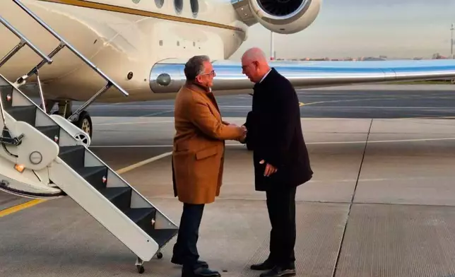 Russian presidential envoy Kirill Dmitriev, right, greets U.S. special envoy Steve Witkoff at the international airport outside St. Petersburg, Russia, Wednesday, Oct. 21, 2026. (TASS Photo via AP)