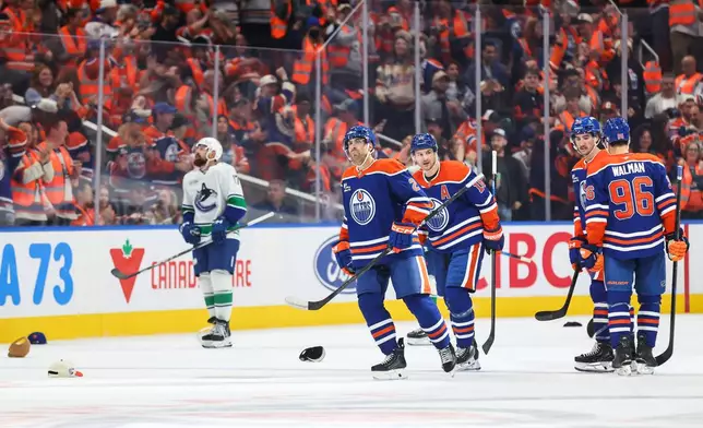 Edmonton Oilers' Evan Bouchard (2) celebrates his hat trick goal against the Vancouver Canucks during third period NHL hockey action in Edmonton on Tuesday, Sept. 29, 2026. (Codie McLachlan/The Canadian Press via AP)