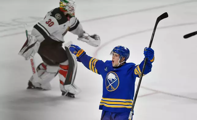 Buffalo Sabres center Jiri Kulich, right, celebrates as Minnesota Wild goalie Jesper Wallstedt skates away after overtime of an NHL hockey game Tuesday, Oct. 6, 2026, in Buffalo, N.Y. (AP Photo/Adrian Kraus)