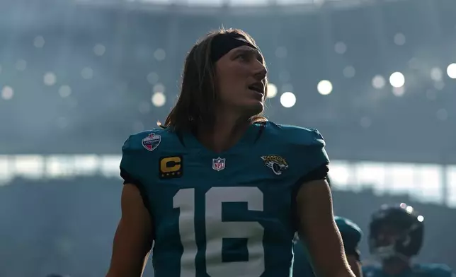 Jacksonville Jaguars quarterback Trevor Lawrence (16) stands on the field before an NFL football game against Philadelphia Eagles in London, Sunday, Oct. 11, 2026. (AP Photo/Ian Walton)