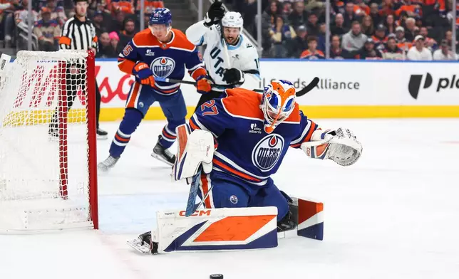 Edmonton Oilers goaltender Devon Levi (27) makes a save against the Utah Mammoth during the third period of an NHL hockey game in Edmonton, Alberta, Thursday, Oct. 15, 2026. (Codie McLachlan/The Canadian Press via AP)