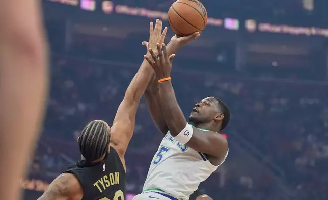 Minnesota Timberwolves guard Anthony Edwards (5) shoots as Cleveland Cavaliers guard Jaylon Tyson (20) defends in the first half of an NBA basketball game, Monday, Oct. 26, 2026, in Cleveland. (AP Photo/Sue Ogrocki)
