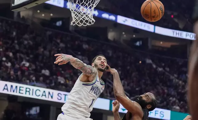 Cleveland Cavaliers guard James Harden, right, defends Minnesota Timberwolves guard LaMelo Ball, left, in the first half of an NBA basketball game, Monday, Oct. 26, 2026, in Cleveland. (AP Photo/Sue Ogrocki)