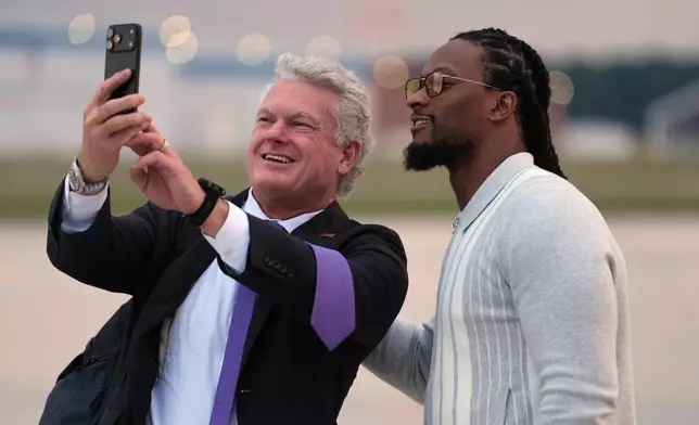 Georgia U.S. Senate candidate Rep. Mike Collins, R-Ga., takes a photo with Todd Gurley before President Donald Trump boards Air Force One, Friday, Oct. 16, 2026, at Dobbins Air Reserve Base, Ga. (AP Photo/Mark Schiefelbein)