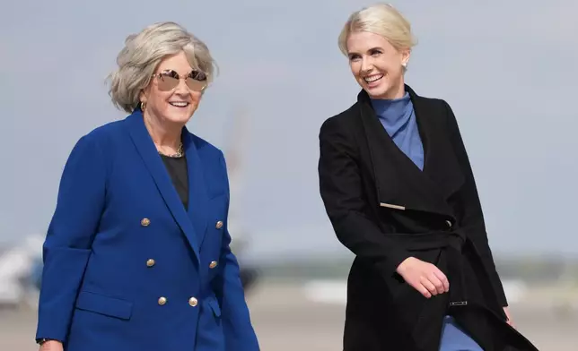 White House chief of staff Susie Wiles and White House aide Natalie Harp walk to board Air Force One, Friday, Oct. 16, 2026, at Joint Base Andrews, Md. (AP Photo/Mark Schiefelbein)