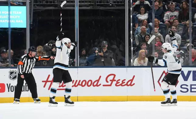 Utah Mammoth's Nick Schmaltz, second from left, celebrates with Clayton Keller, right, after scoring against the Columbus Blue Jackets during the first period of an NHL hockey game, Saturday, Oct. 3, 2026, in Columbus, Ohio. (AP Photo/Tanner Pearson)