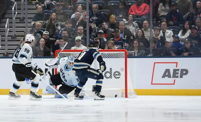 Columbus Blue Jackets' center Kent Johnson (91) scores a goal against the Utah Mammoth during the second period of an NHL hockey game, Saturday, Oct. 3, 2026, in Columbus, Ohio. (AP Photo/Tanner Pearson)