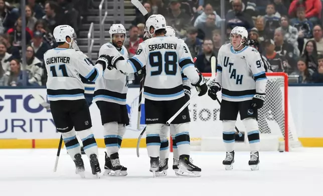 Utah Mammoth's Mikhail Sergachev (98) celebrates with teammates after scoring against the Columbus Blue Jackets during the first period of an NHL hockey game, Saturday, Oct. 3, 2026, in Columbus, Ohio. (AP Photo/Tanner Pearson)