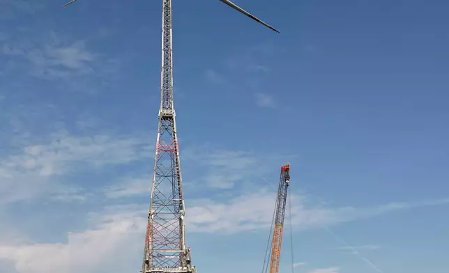A newly constructed wind turbine, whose rotor tips reach a maximum height of 365 meters (1,198 feet), stands in Schipkau, Germany, Thursday, Oct. 1, 2026. (AP Photo/Markus Schreiber)