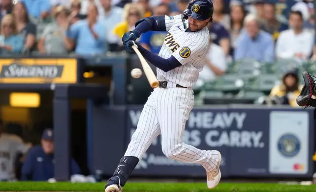 Milwaukee Brewers' Brice Turang hits an RBI single, allowing Jake Bauers, to score during the first inning of a baseball game against the St. Louis Cardinals, Sunday, Sept. 27, 2026, in Milwaukee. (AP Photo/Kayla Wolf)