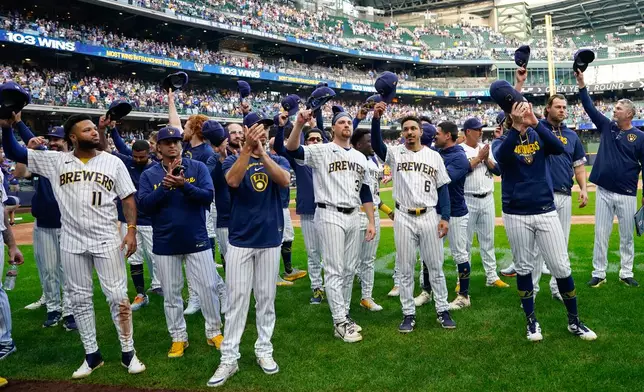 Milwaukee Brewers players tip their caps to fans after winning a baseball game against the St. Louis Cardinals, Sunday, Sept. 27, 2026, in Milwaukee. (AP Photo/Kayla Wolf)