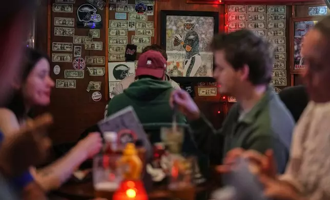 A photo of former Philadelphia Eagles player Nick Foles, who led the team to win its first Super Bowl LII, is displayed on a wall at Passyunk Avenue bar in London, Wednesday, Oct. 7, 2026. (AP Photo/Alastair Grant)