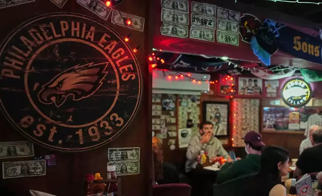 A Philadelphia Eagles emblem is displayed on a wall at the Passyunk Avenue bar in London, Wednesday, Oct. 7, 2026. (AP Photo/Alastair Grant)