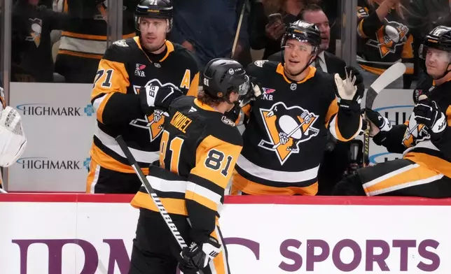 Pittsburgh Penguins' Ben Kindel (81) returns to his bench after scoring during the second period of an NHL hockey game against the Montréal Canadiens in Pittsburgh, Saturday, Oct. 3, 2026. (AP Photo/Gene J. Puskar)