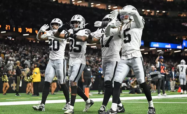 Las Vegas Raiders' Isaiah Pola-Mao (20), Hezekiah Masses (35), Nakobe Dean (17) and Eric Stokes (5) celebrate after Masses intercepted a New Orleans Saints pass during the second half of an NFL football game in New Orleans, Sunday, Sept. 27, 2026. (AP Photo/Ella Hall)